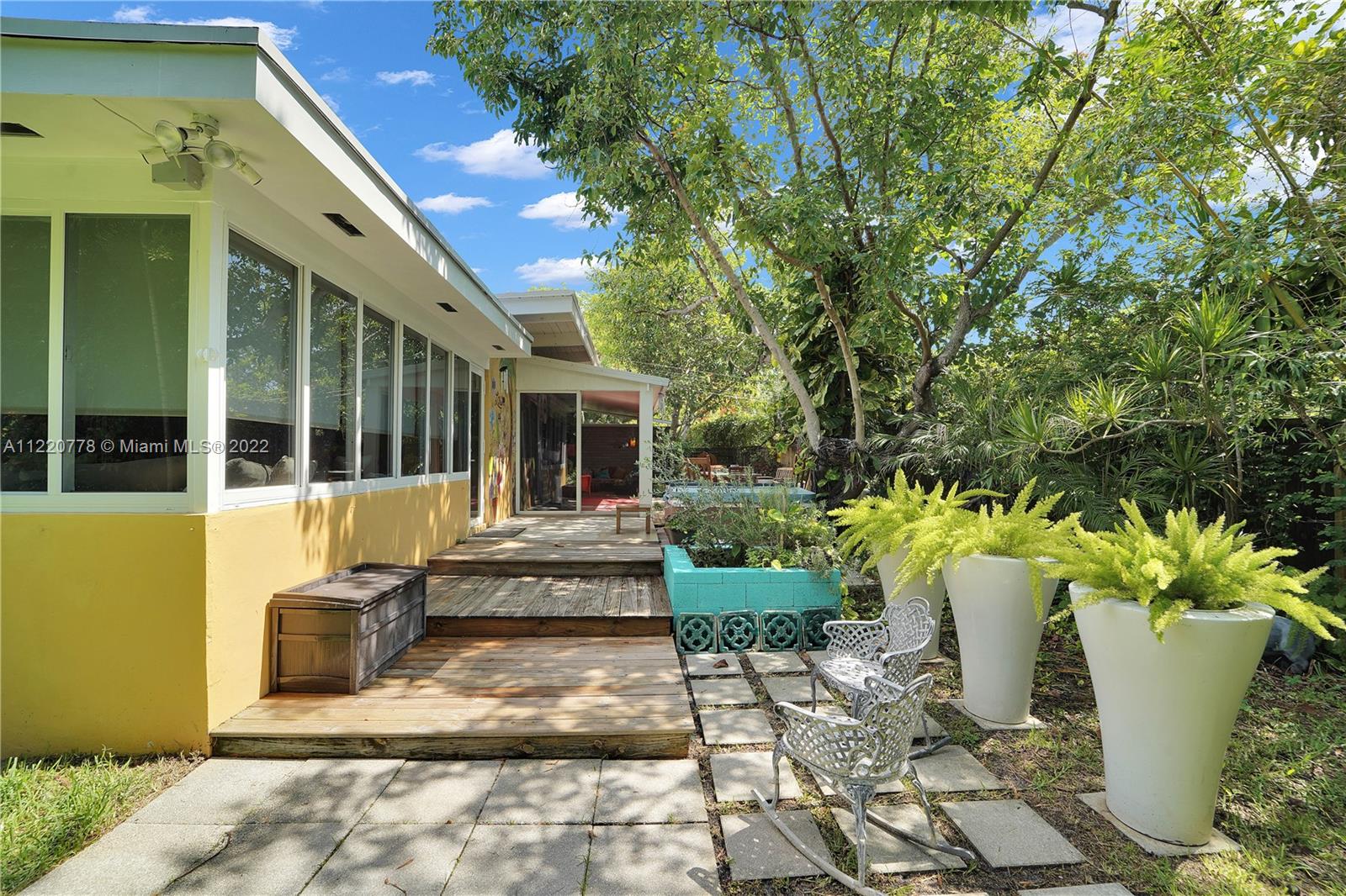 1810 Alamanda Drive North Miami, FL 33181 - Photo 35 of 40 a view of a house with sitting area and potted plants