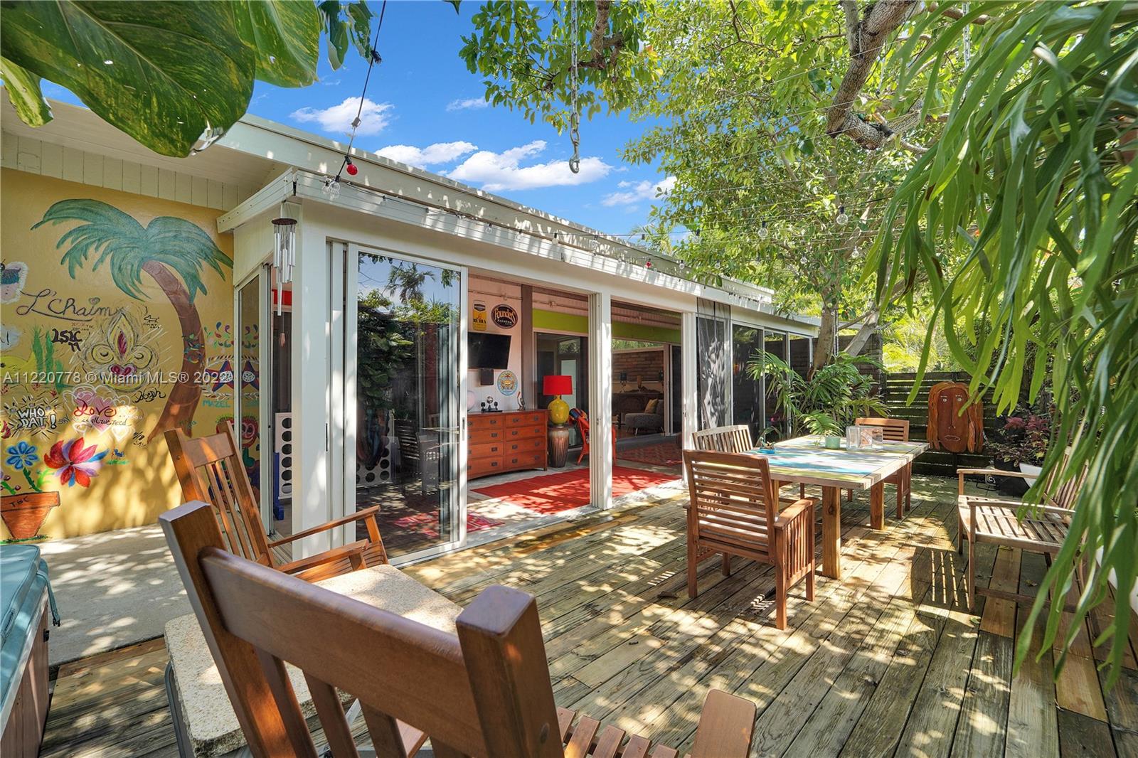 1810 Alamanda Drive North Miami, FL 33181 - Photo 36 of 40 a view of a patio with table and chairs potted plants and large tree