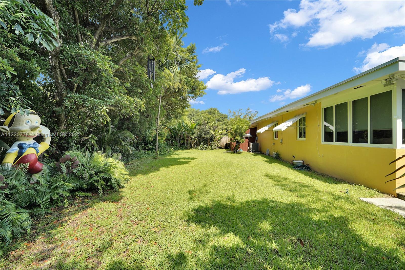 1810 Alamanda Drive North Miami, FL 33181 - Photo 39 of 40 a backyard of a house with yard and outdoor seating