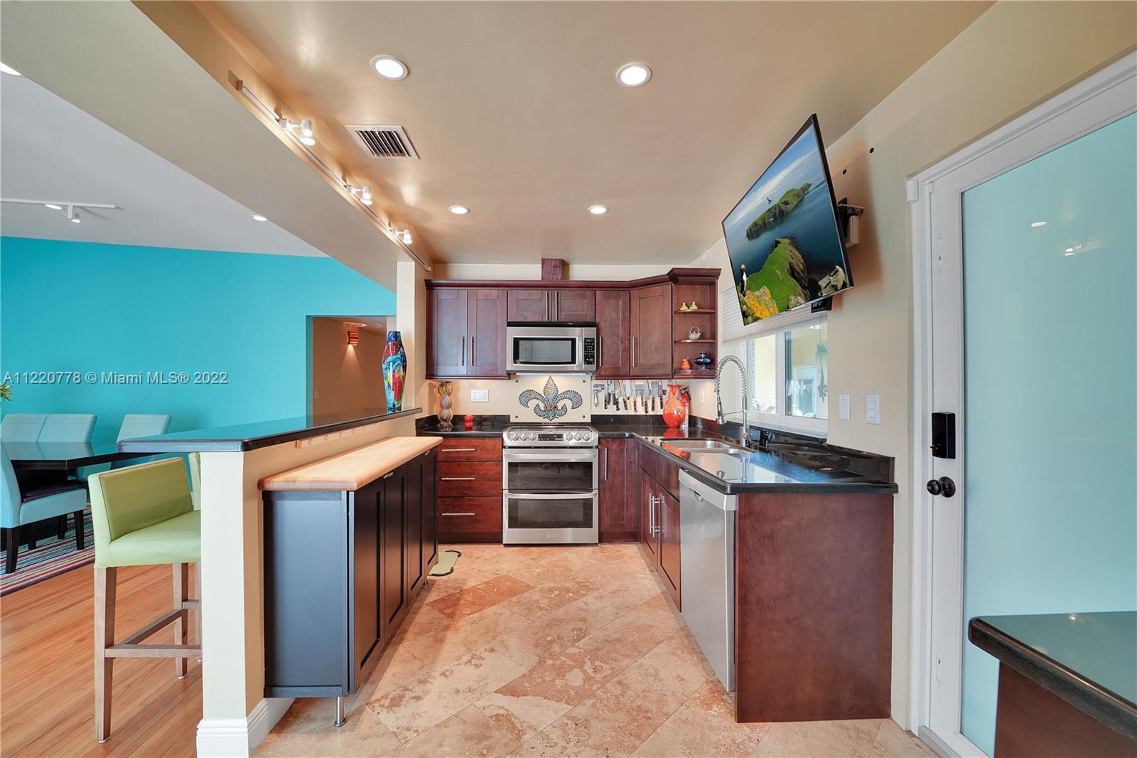 1810 Alamanda Drive North Miami, FL 33181 - Photo 5 of 40 a kitchen with stainless steel appliances granite countertop a stove top oven a sink dishwasher and a refrigerator