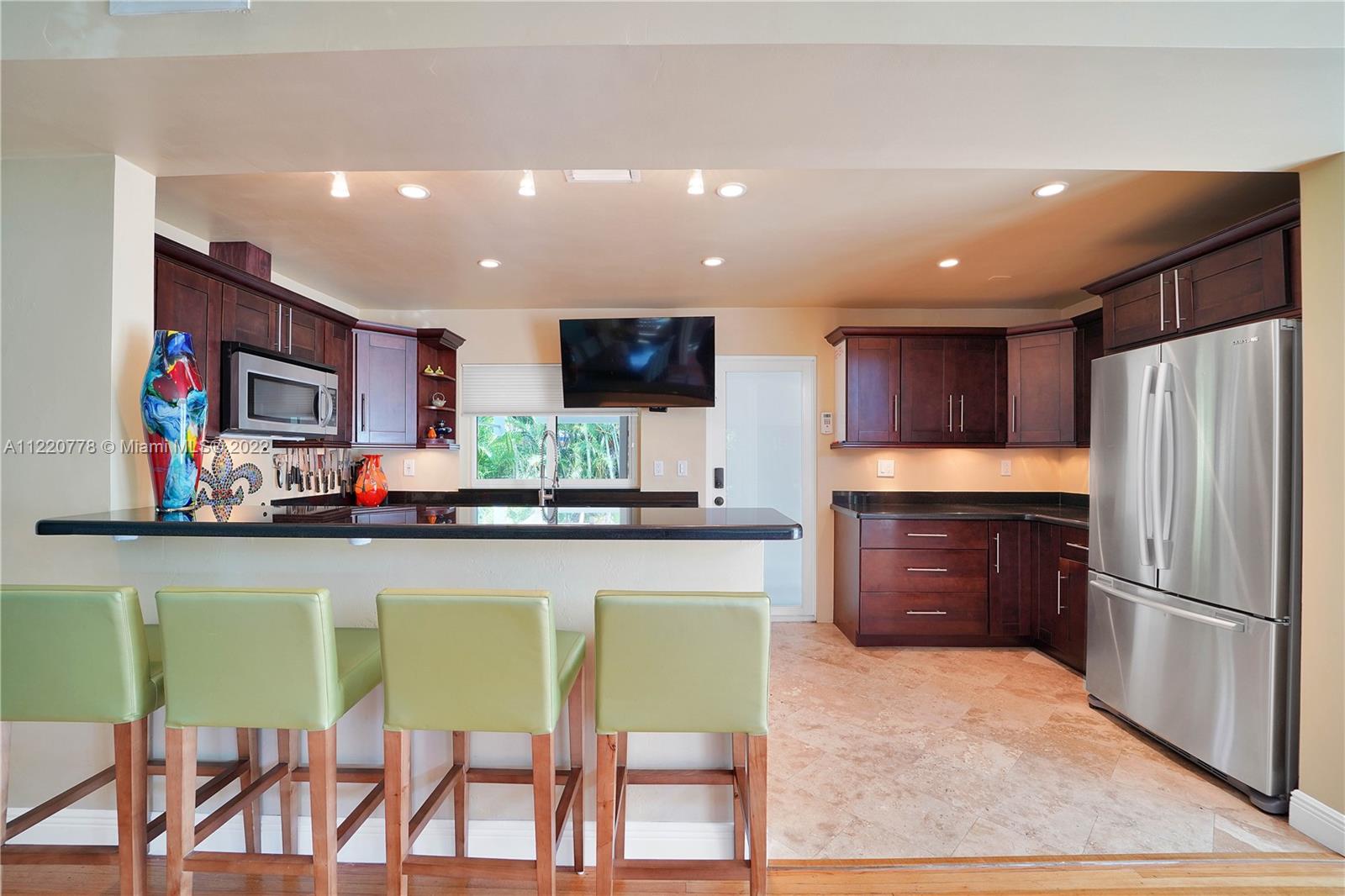1810 Alamanda Drive North Miami, FL 33181 - Photo 9 of 40 a kitchen with stainless steel appliances a refrigerator and a stove top oven