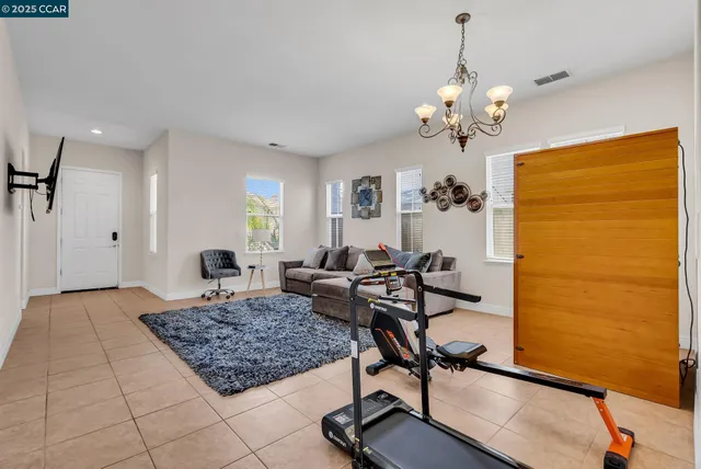 a living room with furniture fireplace and a window
