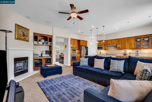 a kitchen that has a lot of cabinets in it and wooden floor