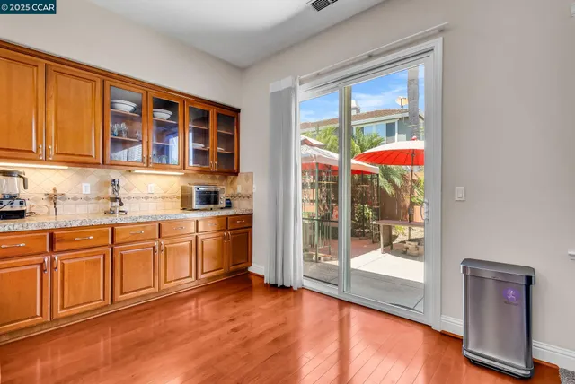a kitchen with stainless steel appliances granite countertop a sink a stove and a refrigerator