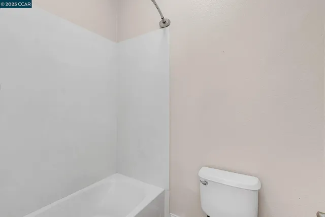 a bedroom with a bed and a lamp on table