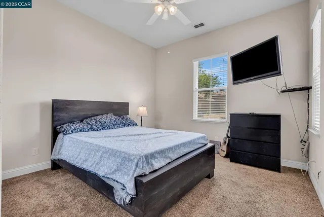 a bedroom with a bed and a television