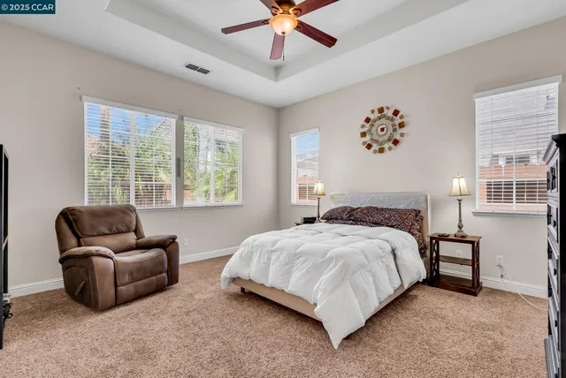 a spacious bathroom with a granite countertop sink a mirror and a bathtub