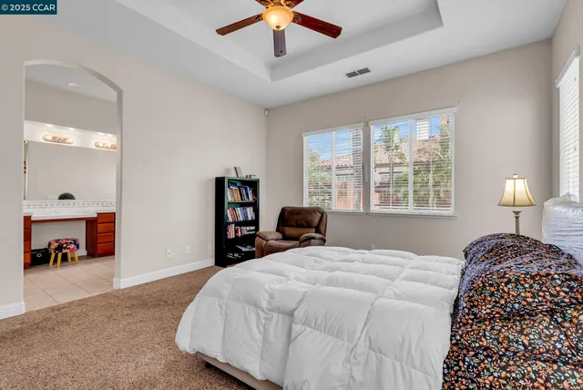 a white bath tub sitting in a bathroom next to a window