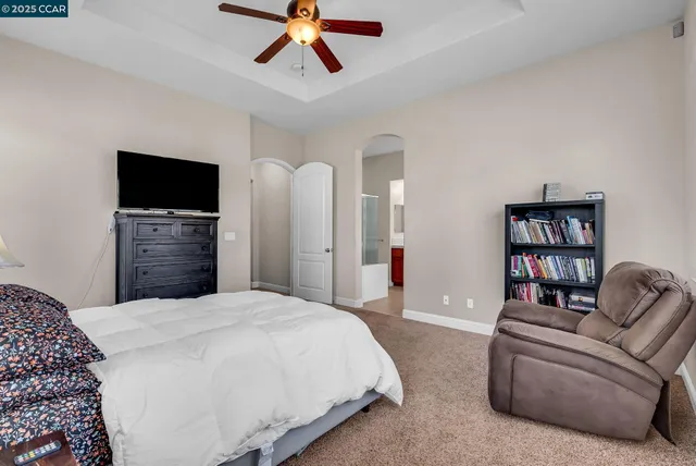 a spacious bathroom with a granite countertop sink mirror and bathtub