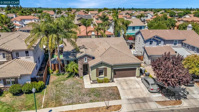 an aerial view of multiple houses with yard