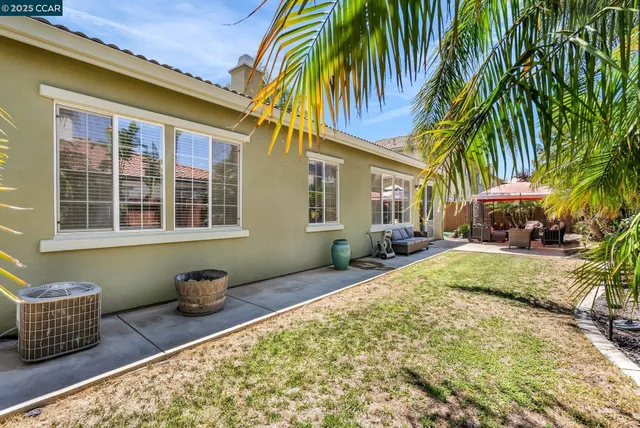 a backyard of a house with table and chairs