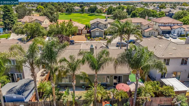 an aerial view of residential houses with outdoor space and swimming pool