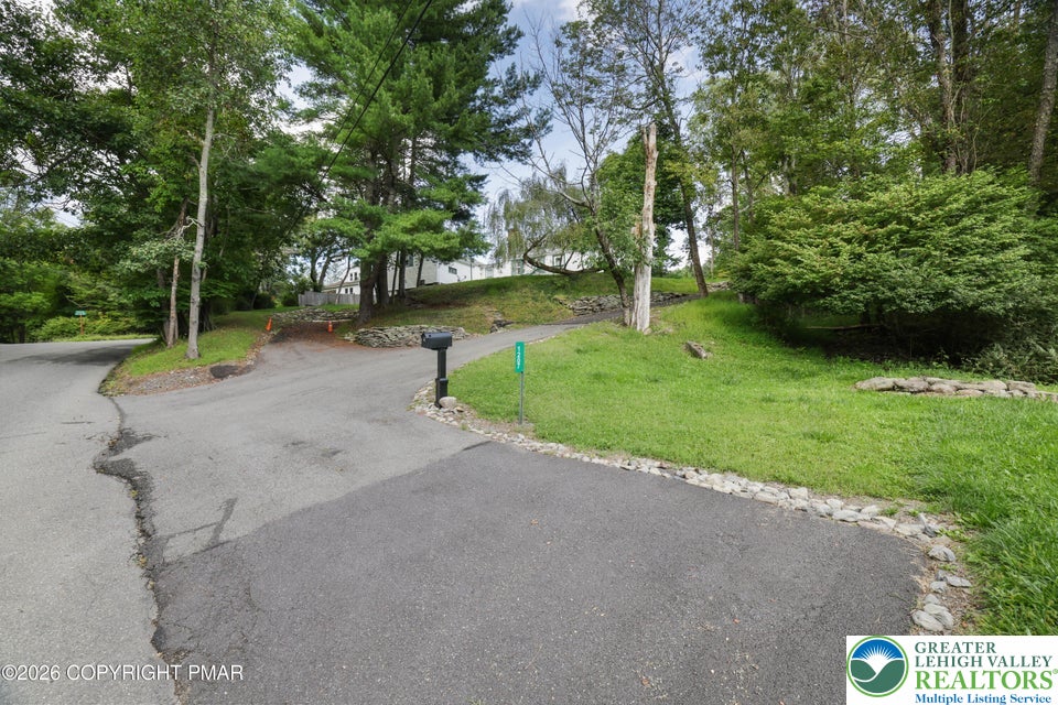 1207 Seese Hill Road Canadensis, PA 18325 - Photo 42 of 49 Mature trees frame the paved driveway leading up to this elevated property.