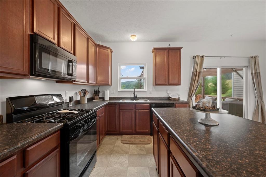 141 Rylie Drive Harmony, PA 16037 - Photo 11 of 31 You will appreciate the coordinating black appliances including the 5 burner gas stove.
