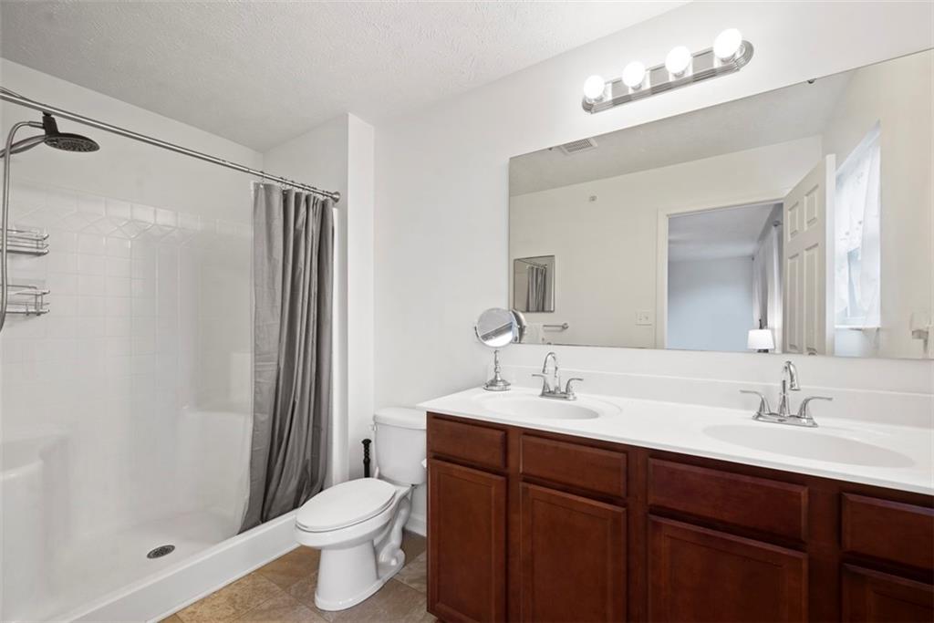 141 Rylie Drive Harmony, PA 16037 - Photo 19 of 31 You will appreciate not only the dual vanity for the shared space but the step in shower for ease of getting in and out of the shower.