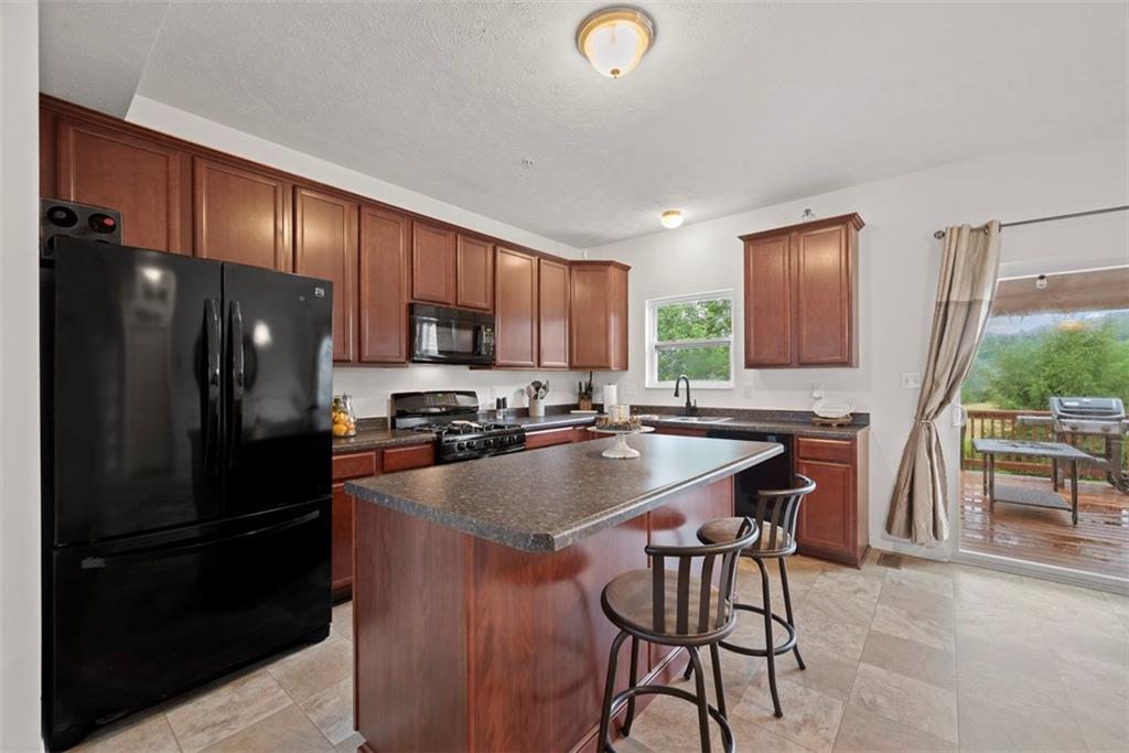 141 Rylie Drive Harmony, PA 16037 - Photo 10 of 31 Start your day with a hot cup of coffee at the oversized kitchen island that can comfortably fit three barstools.