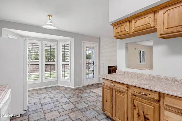 a sink with granite countertop cabinets