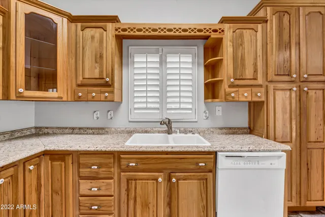 a kitchen with stainless steel appliances a stove a sink and a refrigerator