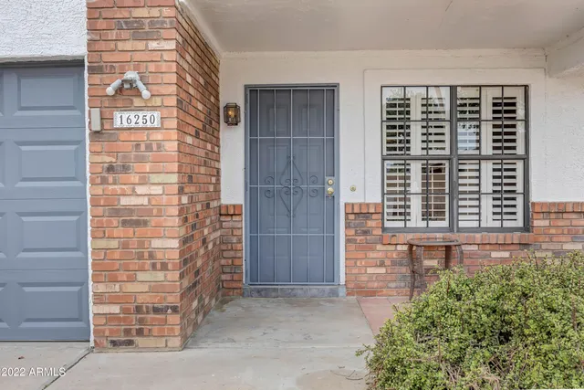 a view of front door of house with stairs