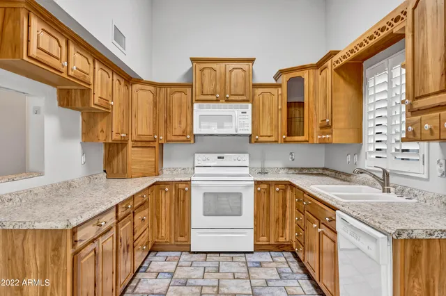 a kitchen with stainless steel appliances granite countertop a sink stove and cabinets