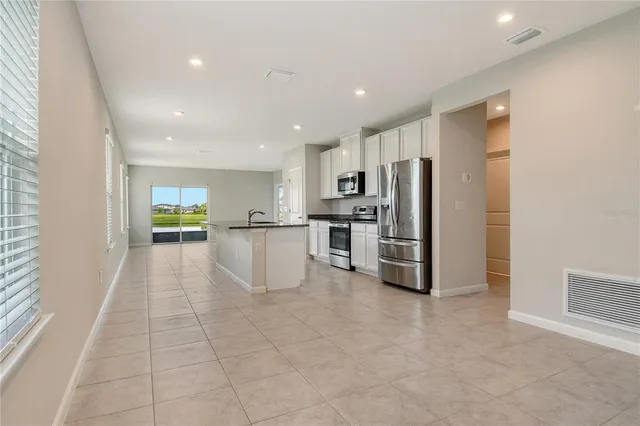 a view of kitchen with stainless steel appliances refrigerator oven microwave and stove