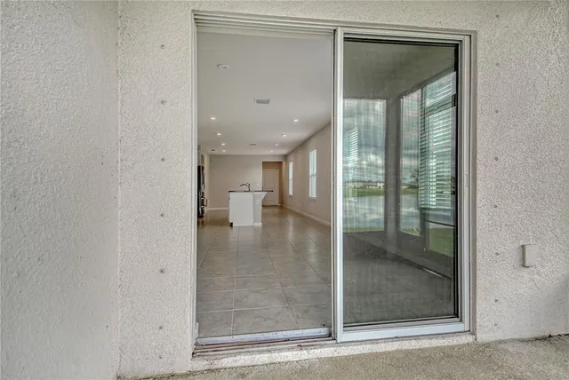 a view of kitchen with refrigerator and chairs