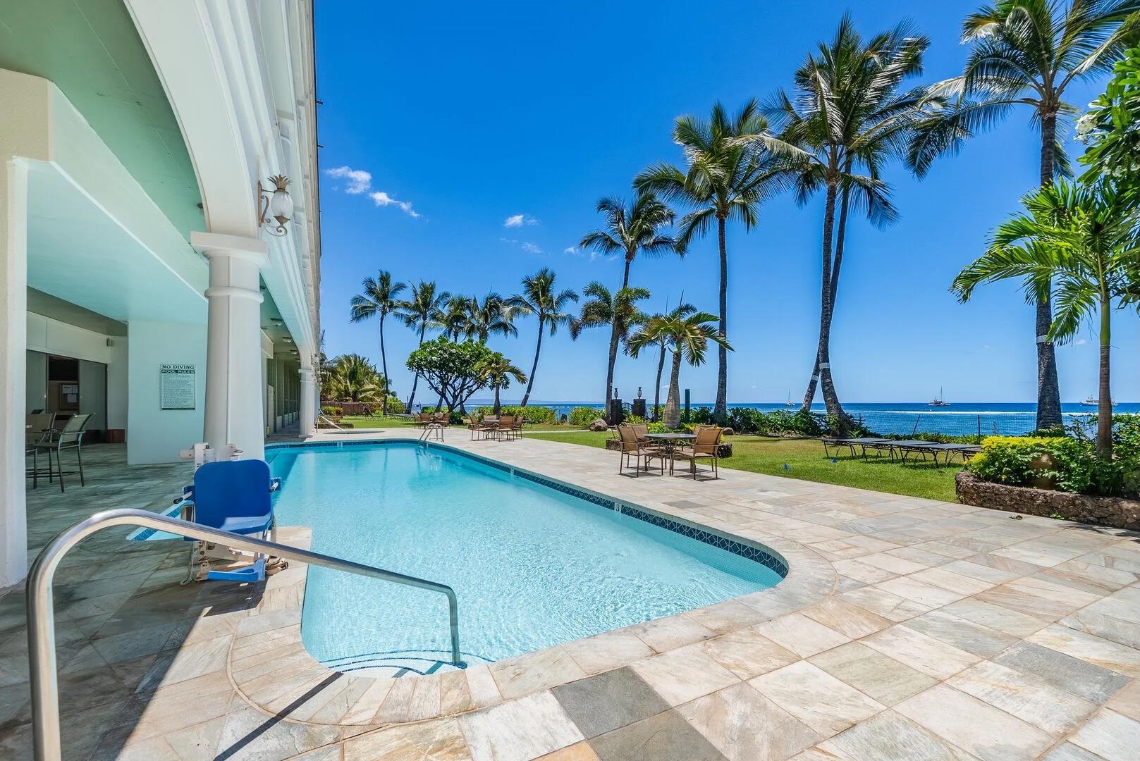 475 Front Street, Unit 419 Lahaina, HI 96761 - Photo 6 of 27 a view of a swimming pool with a lounge chair and palm trees