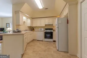 a kitchen with stainless steel appliances granite countertop a refrigerator sink and stove