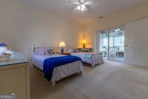 a spacious bedroom with a bed and a chandelier