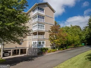 a front view of a residential apartment building with a yard