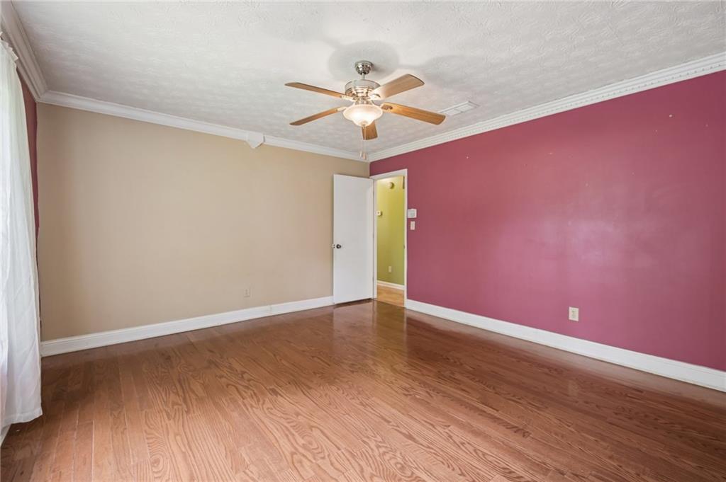 1318 Panhandle Way Hampton, GA 30228 - Photo 8 of 22 a view of an empty room with window and wooden floor