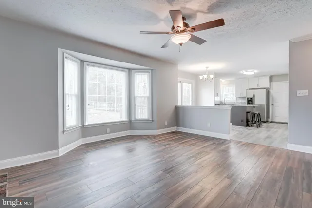 a kitchen with kitchen island granite countertop a stove sink and microwave