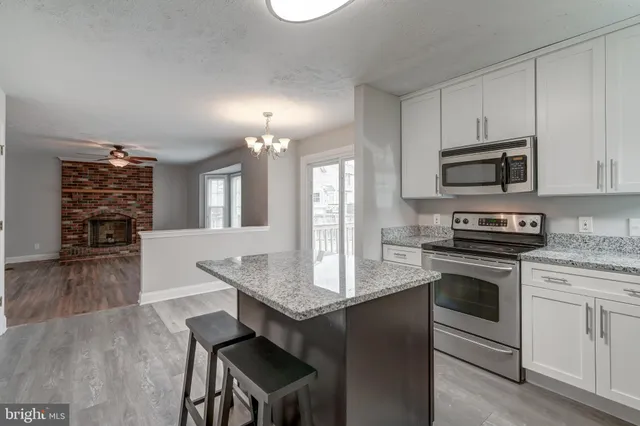 a view of a hallway with a livingroom and a bathroom