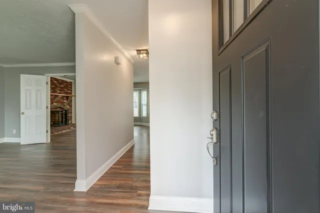 a view of an entryway with wooden floor
