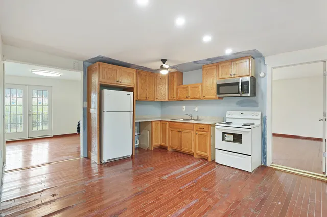 a kitchen with stainless steel appliances granite countertop a refrigerator and a stove top oven