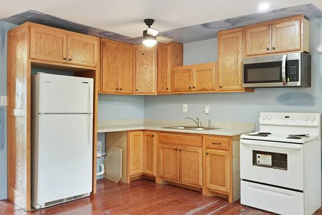 a kitchen with stainless steel appliances a stove a microwave and a refrigerator
