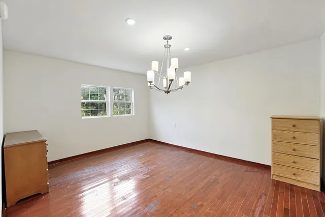 an empty room with a empty space and windows