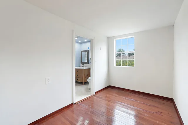 a view of a livingroom with furniture and hardwood floor