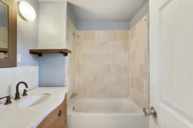 a view of a balcony with wooden floor and fence
