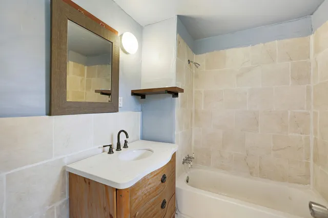 a view of a pathway of a house with wooden fence