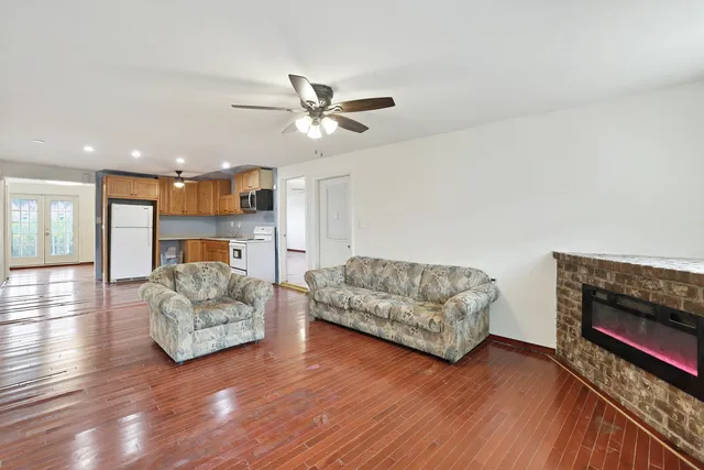 a living room with furniture and a wooden floor