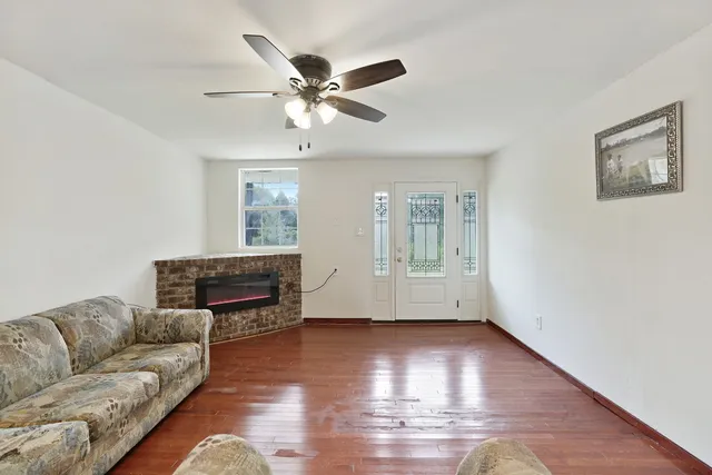 a living room with furniture and a wooden floor