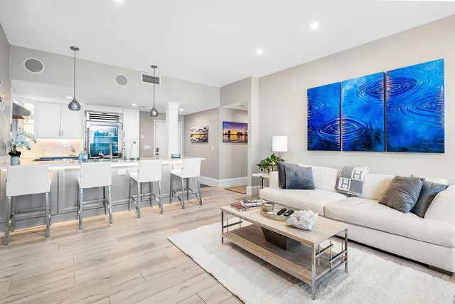 a kitchen with stainless steel appliances kitchen island granite countertop a table and chairs in it