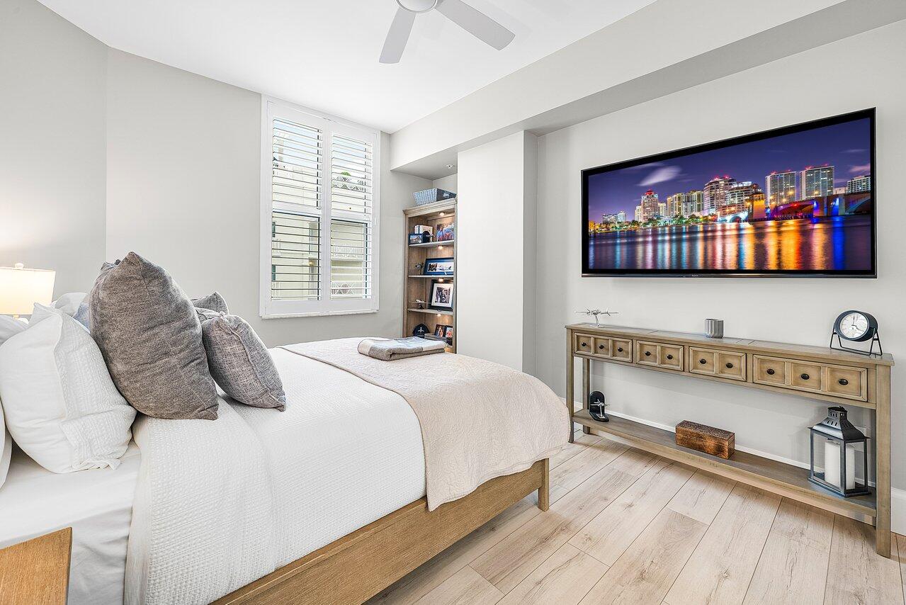 255 Evernia Street, Unit 1502 West Palm Beach, FL 33401 - Photo 14 of 40 a bedroom with a bed and a flat screen tv