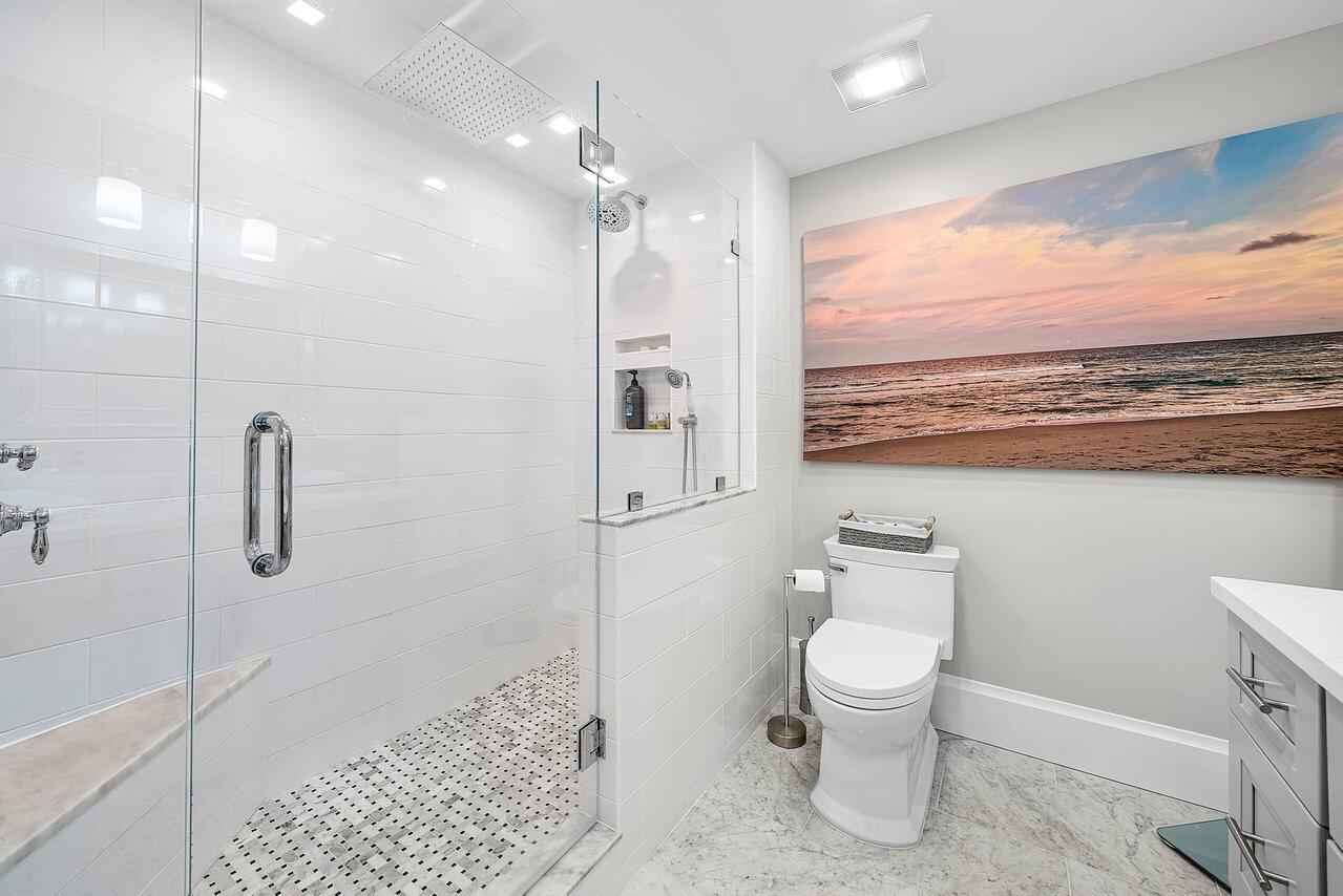 255 Evernia Street, Unit 1502 West Palm Beach, FL 33401 - Photo 18 of 40 a bathroom with a toilet sink and shower
