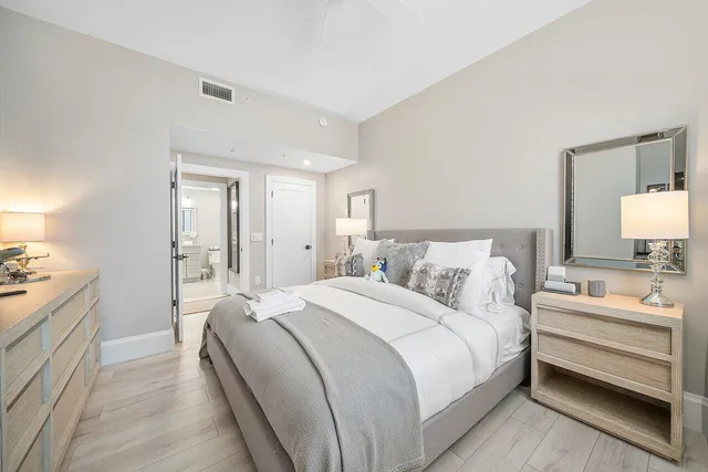 a bathroom with a double vanity sink toilet mirror and shower