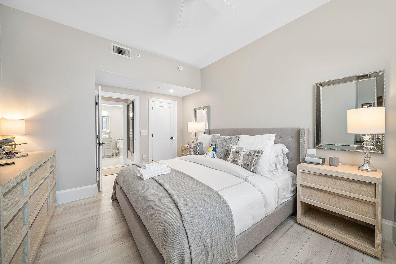 255 Evernia Street, Unit 1502 West Palm Beach, FL 33401 - Photo 20 of 40 a bedroom with a bed and a couch