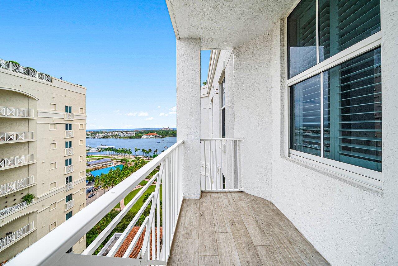 255 Evernia Street, Unit 1502 West Palm Beach, FL 33401 - Photo 24 of 40 a view of a balcony with wooden floor and fence
