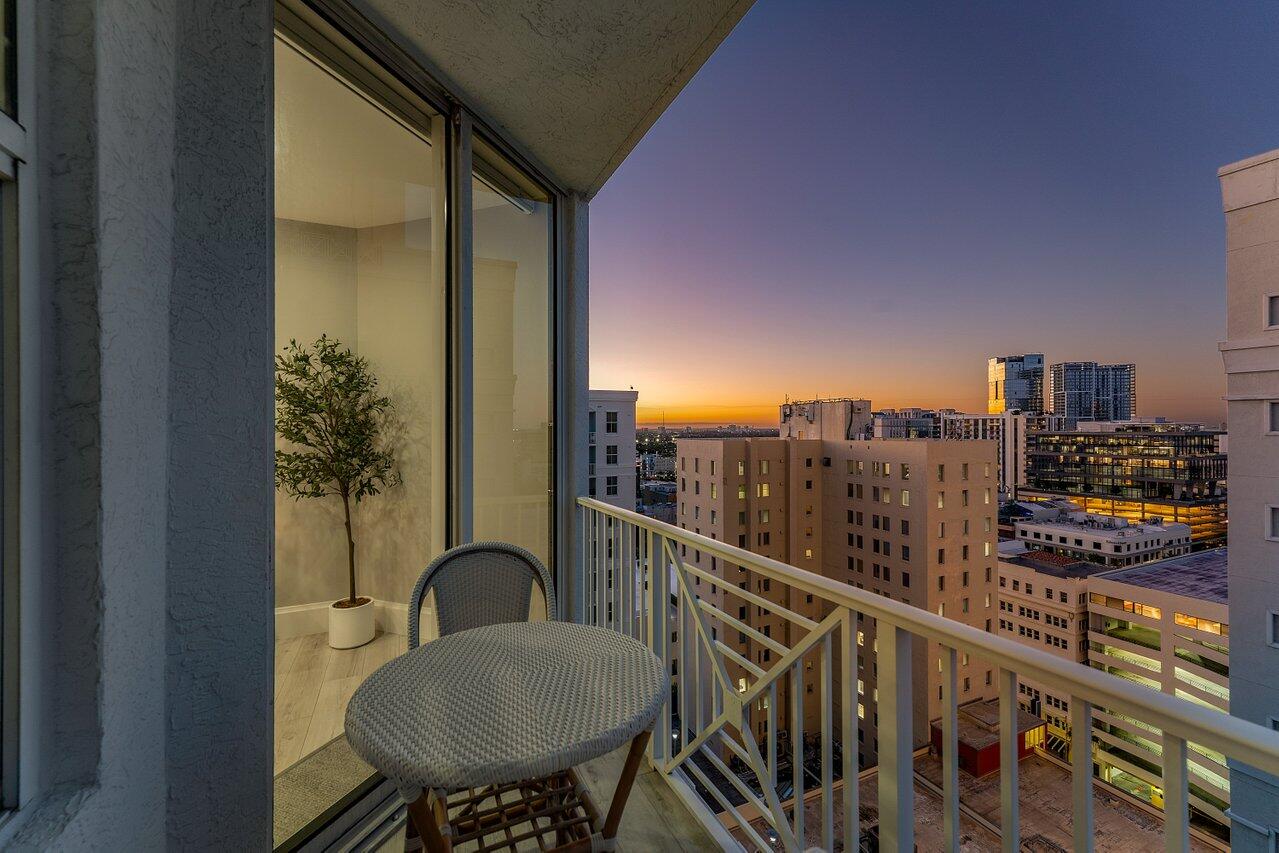 255 Evernia Street, Unit 1502 West Palm Beach, FL 33401 - Photo 28 of 40 a balcony with a table and chairs