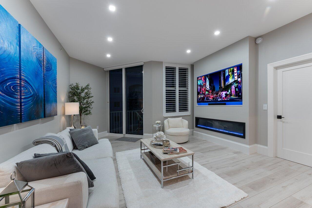 255 Evernia Street, Unit 1502 West Palm Beach, FL 33401 - Photo 29 of 40 a living room with furniture and a flat screen tv